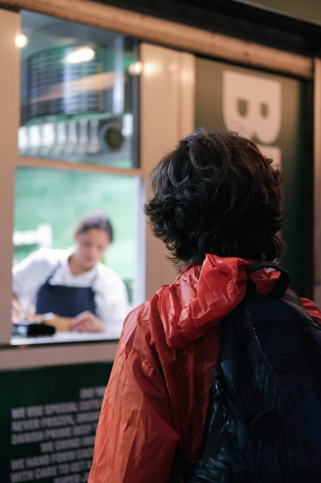 Person analyzing documents and a screen with charts