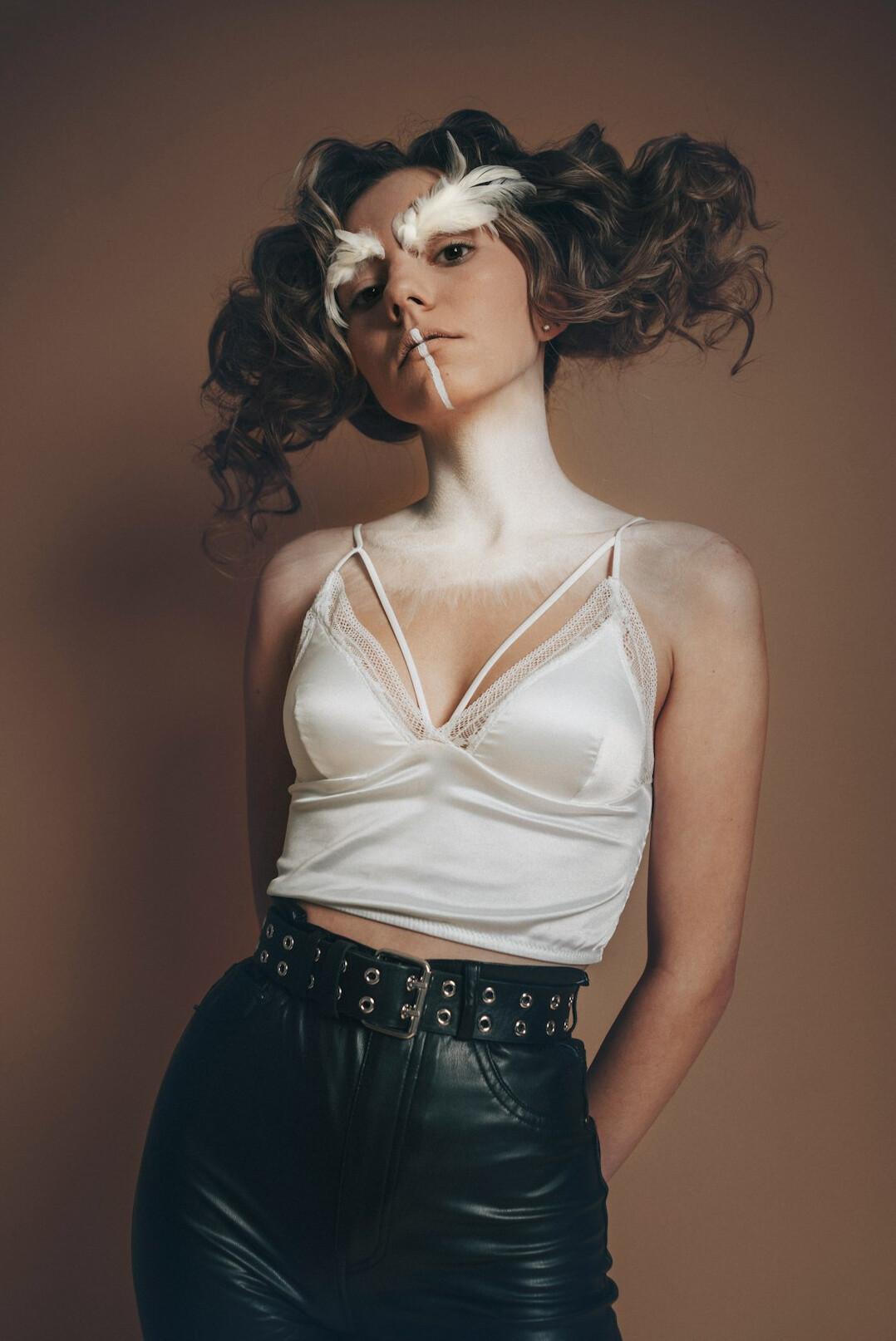 Studio portrait of a young woman with curly hair