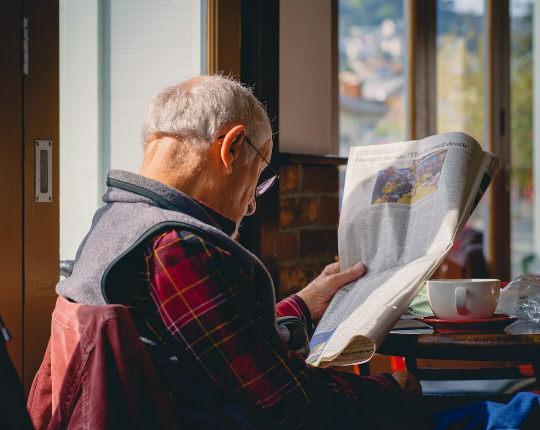 person reading newspaper
